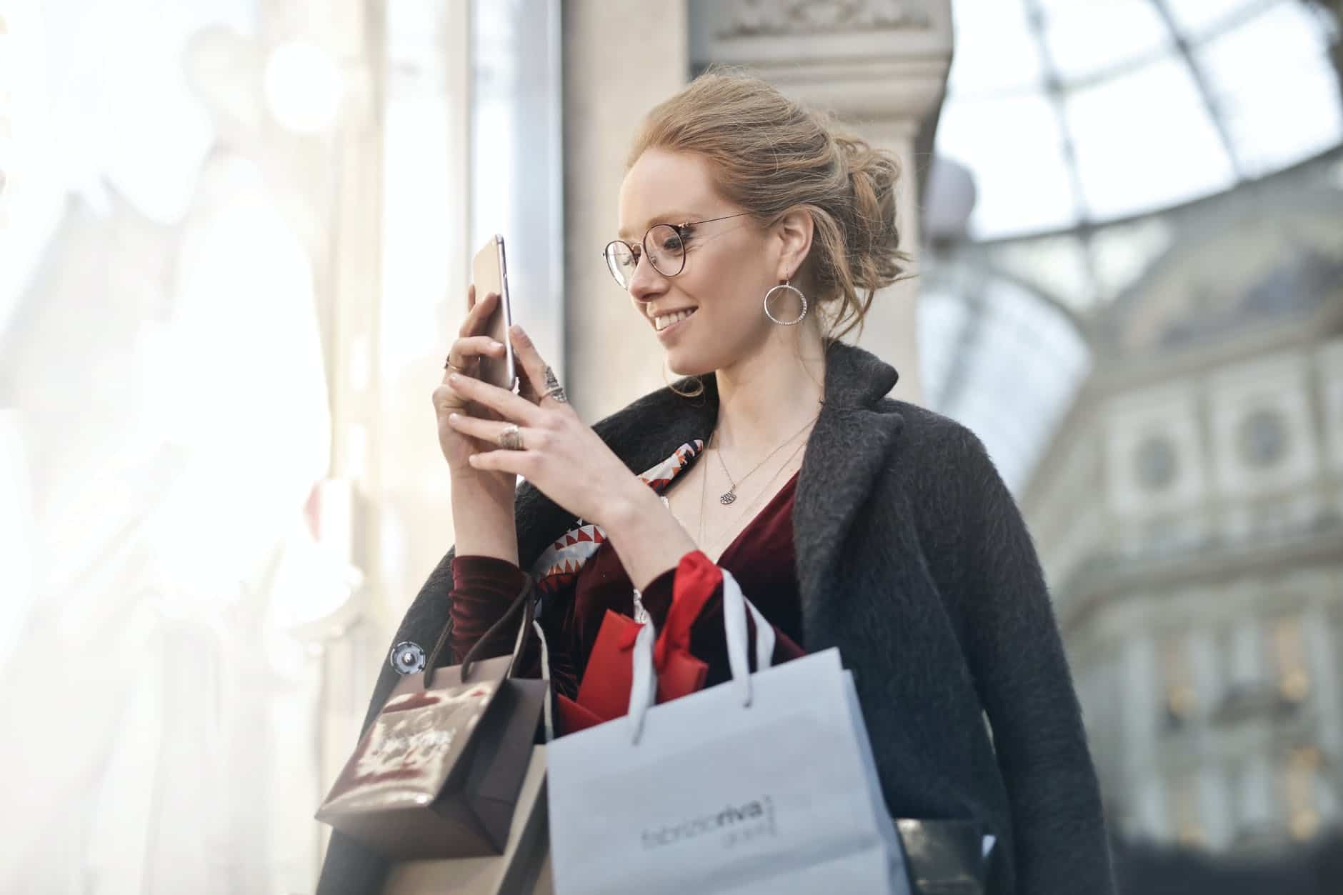 photo of woman holding her phone